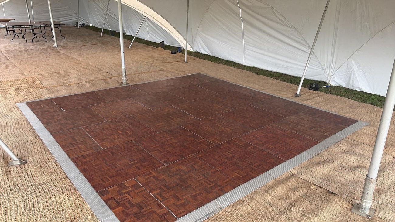 Parquet dance floor and coir matting inside a Capri marquee