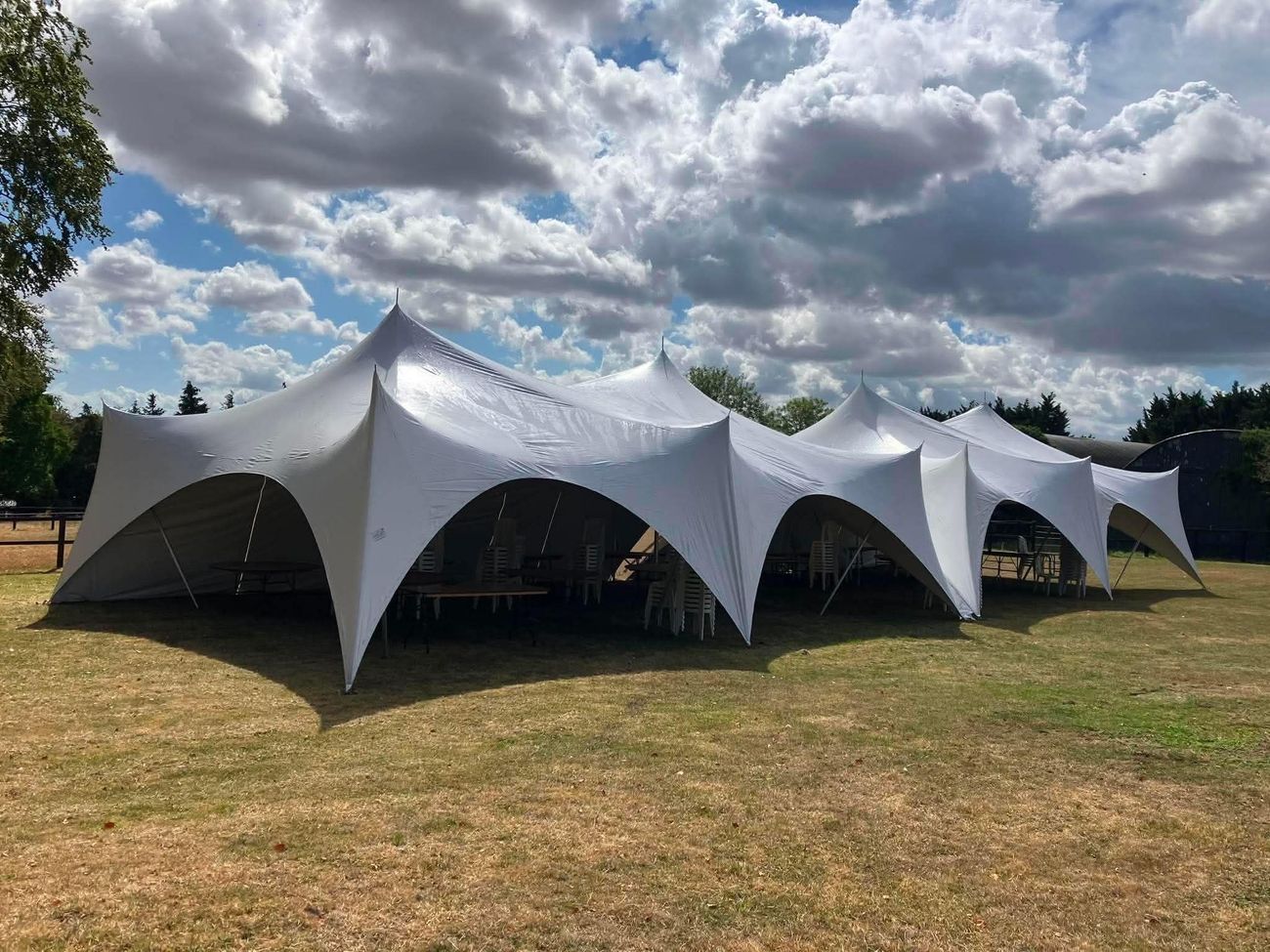 Two linked Capri marquees with the side walls open on a sunny day